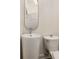 Elegant powder room with modern pedestal sink, stylish fixtures, and decorative mirror at 591 E Morningside Ne Dr, Atlanta, GA 30324