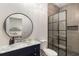 Modern bathroom with a walk-in shower, designer vanity and a round mirror at 591 E Morningside Ne Dr, Atlanta, GA 30324