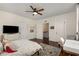 This bedroom features a ceiling fan, hardwood floors, and a decorative rug at 591 E Morningside Ne Dr, Atlanta, GA 30324