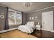 This bedroom features hardwood floors, a large window, and a decorative ceiling light at 591 E Morningside Ne Dr, Atlanta, GA 30324