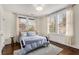 This bedroom features hardwood floors, multiple windows, and a soft color scheme at 591 E Morningside Ne Dr, Atlanta, GA 30324