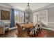 Dining room features a wooden table, elegant chandelier, and natural light from large windows at 591 E Morningside Ne Dr, Atlanta, GA 30324