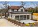 Stunning Tudor-style home featuring a new three-car garage and professionally landscaped yard at 591 E Morningside Ne Dr, Atlanta, GA 30324