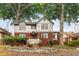Charming two-story home with a brick and stucco exterior, set amidst mature trees and a landscaped front yard at 591 E Morningside Ne Dr, Atlanta, GA 30324