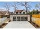 Rear view of home's garage with 3 doors and concrete parking pad at 591 E Morningside Ne Dr, Atlanta, GA 30324