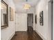 Inviting hallway is adorned with modern art, a stylish chandelier, and hardwood floors at 591 E Morningside Ne Dr, Atlanta, GA 30324