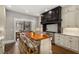 Eat-in kitchen with island seating, white cabinetry, and stainless steel appliances is ideal for gatherings at 591 E Morningside Ne Dr, Atlanta, GA 30324