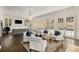 Spacious living room with hardwood floors, a modern sofa, and stylish white accent chairs at 591 E Morningside Ne Dr, Atlanta, GA 30324