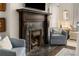 A living room view features a marble fireplace with dark wood trim and light blue armchairs at 591 E Morningside Ne Dr, Atlanta, GA 30324