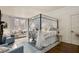 Spacious main bedroom with canopy bed, fireplace, sitting area, and plenty of windows at 591 E Morningside Ne Dr, Atlanta, GA 30324