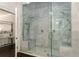 Spacious glass shower features marble surround, dual shower heads, and built-in bench at 591 E Morningside Ne Dr, Atlanta, GA 30324