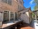 This brick patio has a wooden deck, with a wooden table set for dining and a set of patio heaters at 7920 Georgetown Cir, Suwanee, GA 30024