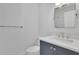 A modern bathroom featuring a sleek vanity with white countertops, a vessel sink, and a large mirror at 205 Thomas Cir, Roswell, GA 30075