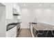 Gourmet kitchen featuring stainless steel appliances, marble backsplash, and black countertops at 223 16Th Nw St # 8, Atlanta, GA 30363