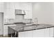 Gourmet kitchen featuring stainless steel appliances, marble backsplash, and black countertops at 223 16Th Nw St # 8, Atlanta, GA 30363