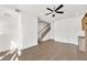 Open-concept living room with hardwood floors, staircase, and ceiling fan at 223 16Th Nw St # 8, Atlanta, GA 30363