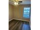 Cozy bedroom features modern ceiling fan, window with blinds, and wood-look laminate flooring at 4155 Park Chase Dr, Atlanta, GA 30344