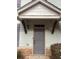 Inviting front door with covered entrance and stone accents providing a welcoming curb appeal at 4155 Park Chase Dr, Atlanta, GA 30344