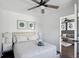 Cozy bedroom with queen bed, plush bedding, ceiling fan, and ensuite access to living room at 215 Piedmont Ne Ave # 2201, Atlanta, GA 30308