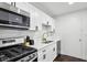 Bright kitchen features white cabinets, updated appliances, and marble backsplash at 215 Piedmont Ne Ave # 2201, Atlanta, GA 30308