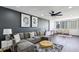 Relax in this modern living room featuring a gray sofa, plush rug, and natural light from the large window at 215 Piedmont Ne Ave # 2201, Atlanta, GA 30308