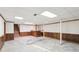 Unfinished basement with a retro bar, wood paneling, and concrete floors, ready for renovation at 4833 Village North Ct, Atlanta, GA 30338