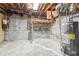 Unfinished basement with exposed pipes, water heater, concrete blocks and exposed ceiling at 4833 Village North Ct, Atlanta, GA 30338