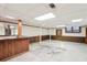 Unfinished basement with a retro bar, wood paneling, and concrete floors, ready for renovation at 4833 Village North Ct, Atlanta, GA 30338