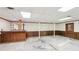 Unfinished basement with a retro bar, wood paneling, and concrete floors, ready for renovation at 4833 Village North Ct, Atlanta, GA 30338