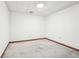 Empty basement room with white walls, stained concrete floor and wood trim at 4833 Village North Ct, Atlanta, GA 30338