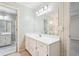 Traditional bathroom featuring a white vanity with a large mirror and complementary patterned wallpaper at 4833 Village North Ct, Atlanta, GA 30338