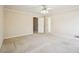 Spacious bedroom features a ceiling fan, neutral walls and carpet, with door open and closet at 4833 Village North Ct, Atlanta, GA 30338