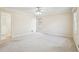 Spacious bedroom features a ceiling fan, neutral walls and carpet and a large window at 4833 Village North Ct, Atlanta, GA 30338