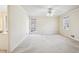 Spacious bedroom features a ceiling fan, neutral walls and carpet and double windows at 4833 Village North Ct, Atlanta, GA 30338
