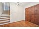 Bright foyer with chandelier lighting, staircase, and hardwood floors at 4833 Village North Ct, Atlanta, GA 30338