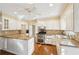 Well-lit kitchen featuring white cabinets, granite countertops, stainless steel appliances, and hardwood floors at 4833 Village North Ct, Atlanta, GA 30338