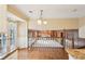 Open concept kitchen with hardwood floors, granite counters, and view to the Gathering room at 4833 Village North Ct, Atlanta, GA 30338
