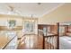 Open concept kitchen area with hardwood floors, granite counters, and view to the Gathering room at 4833 Village North Ct, Atlanta, GA 30338
