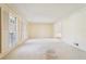 Spacious living room with large windows and neutral carpet and paint at 4833 Village North Ct, Atlanta, GA 30338