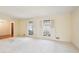 Bright living room with neutral carpet, large windows with shutters, and view to adjacent rooms at 4833 Village North Ct, Atlanta, GA 30338