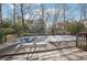 A partially covered pool is adjacent to a back deck with wooden railings at 4833 Village North Ct, Atlanta, GA 30338