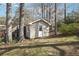 A quaint storage shed provides practical space in a private backyard setting at 4833 Village North Ct, Atlanta, GA 30338