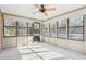 Inviting sunroom featuring multiple windows, a ceiling fan, and an adjacent patio at 4833 Village North Ct, Atlanta, GA 30338