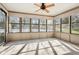 Bright sunroom with large windows offering abundant natural light and a view of the lush backyard at 4833 Village North Ct, Atlanta, GA 30338