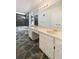 Bathroom featuring double sinks, white cabinets, and a stone accent wall at 105 Creekwood Ln, Fayetteville, GA 30214