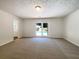 Spacious bedroom with a sliding door to the pool, carpeted floors, and natural light at 105 Creekwood Ln, Fayetteville, GA 30214
