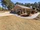 Brick home featuring mature trees, manicured lawn, and beautiful paved walkway at 105 Creekwood Ln, Fayetteville, GA 30214