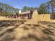 Charming brick home with manicured lawn, mature trees and a newly installed wooden fence at 105 Creekwood Ln, Fayetteville, GA 30214