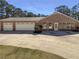 Home featuring a three-car garage with ample parking space on a spacious concrete driveway at 105 Creekwood Ln, Fayetteville, GA 30214
