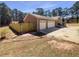 Home featuring a three-car garage with newly installed wooden fence, offering privacy and security at 105 Creekwood Ln, Fayetteville, GA 30214